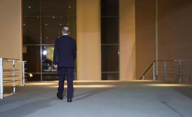 German Chancellor Olaf Scholz leaves after making a statement after a meeting with government leaders in Berlin, Germany, Wednesday, Nov. 6, 2024. (AP Photo/Markus Schreiber)