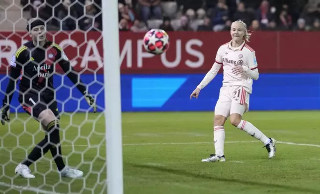 Bayern's Pernille Harder, right, scores the opening goall during the women's Champions League group C soccer match between FC Bayern Munich and Valerenga at the FC Bayern Campus in Munich, Germany, Tuesday, Nov. 12, 2024. (AP Photo/Matthias Schrader)