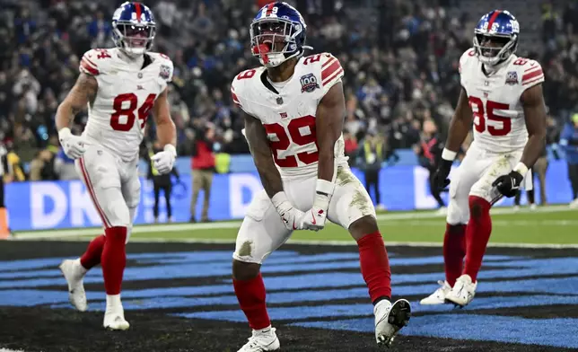 New York Giants running back Tyrone Tracy Jr. celebrates after scoring against the Carolina Panthers during the second half of an NFL football game, Sunday, Nov. 10, 2024, in Munich, Germany. (AP Photo/Lennart Preiss)