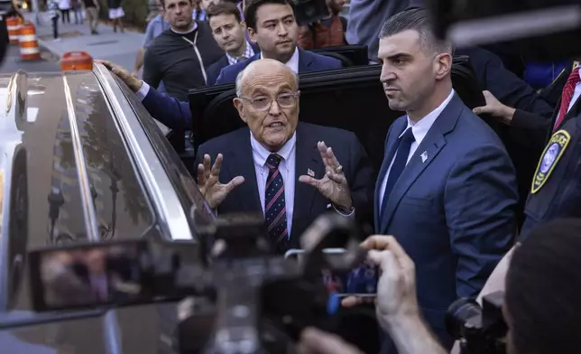 Former New York City Mayor Rudy Giuliani speaks to the members of the media as he leaves court in New York, Thursday, Nov. 7, 2024. (AP Photo/Yuki Iwamura)