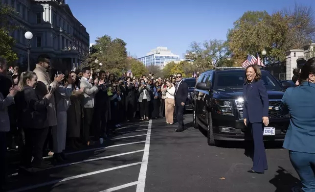 Vice President Kamala Harris smiles to hundreds of gathered administration staff as they give her an ovation after she arrived outside the White House in Washington, Tuesday, Nov. 12, 2024. (AP Photo/Ben Curtis)