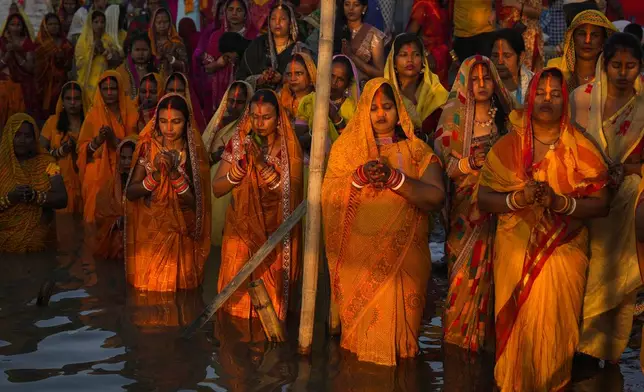 Hindu devotees gather by the river Brahmaputra and offer prayers during Chhath Puja festival in Guwahati, northeastern Assam state, India, Thursday, Nov. 7, 2024. (AP Photo/Anupam Nath)