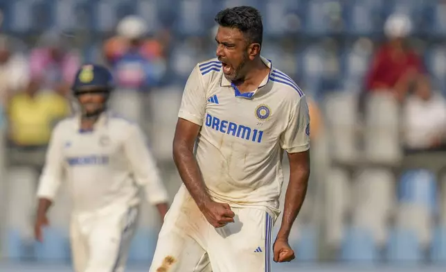 India's Ravichandran Ashwin celebrates the dismissal of New Zealand's Glenn Phillips during the second day of the third cricket test match between India and New Zealand at Wankhede Stadium, in Mumbai, India, Saturday, Nov. 2, 2024.(AP Photo/Rajanish Kakade)