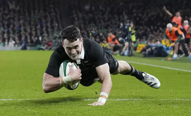 New Zealand's Will Jordan scores a try during the the Autumn Nations series rugby union match between Ireland and New Zealand at the Aviva Stadium in Dublin, Ireland, Friday, Nov. 8, 2024. (Brian Lawless/PA via AP)