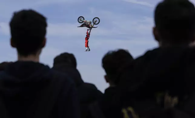 Riders perform during a freestyle motocross show at the EICMA exhibition motorcycle fair in Rho, outskirt of Milan, Italy, Thursday, Nov. 7, 2024. (AP Photo/Luca Bruno)