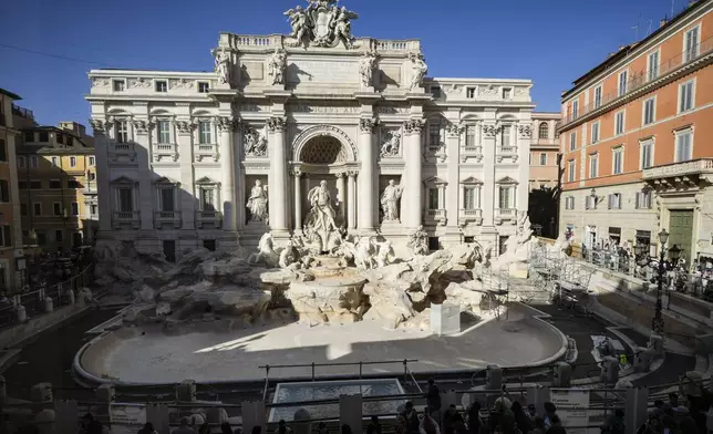 A small pool is seen in front of the Trevi Fountain to allow tourists to throw their coins in it, as the fountain has been emptied to undergo maintenance work that will last until around September 2025, in Rome, Friday, Nov. 1, 2024. (AP Photo/Andrew Medichini)