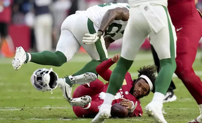 Arizona Cardinals quarterback Kyler Murray has his helmet knocked off during sack by New York Jets defensive tackle Quinnen Williams during the first half of an NFL football game, Sunday, Nov. 10, 2024, in Glendale, Ariz. (AP Photo/Ross D. Franklin)