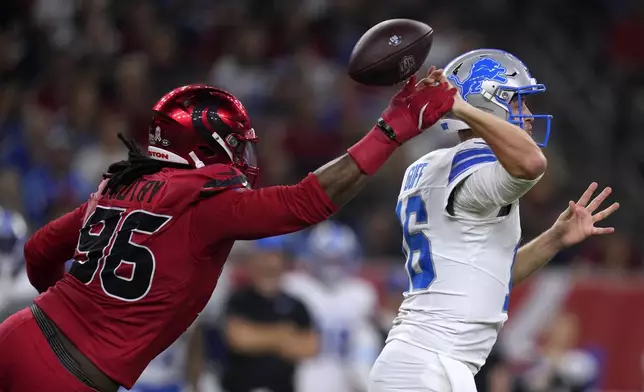 Houston Texans defensive end Denico Autry (96) hits Detroit Lions quarterback Jared Goff (16) as he throws a pass during the first half of an NFL football game, Sunday, Nov. 10, 2024, in Houston. (AP Photo/Eric Christian Smith)