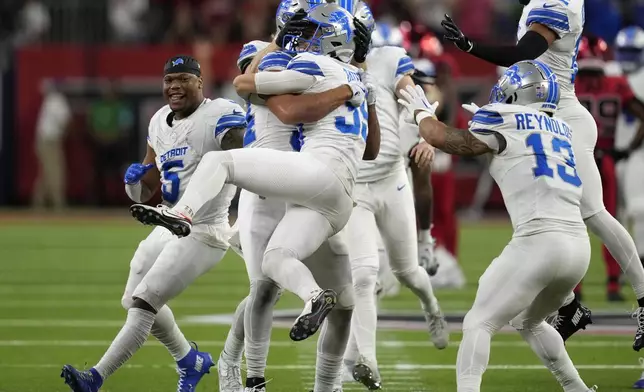 Detroit Lions place kicker Jake Bates (39) celebrates with teammates after kicking a 52-yard field goal at the end of an NFL football game against the Houston Texans, Sunday, Nov. 10, 2024, in Houston. The Lions won 26-23. (AP Photo/David J. Phillip)