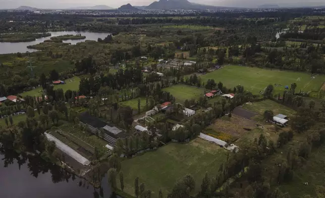 Small ancestral floating gardens are visible next to new soccer fields on the Xochimilco Lake in the Xochimilco borough of Mexico City, on Sunday, Oct. 20, 2024. (AP Photo/Felix Marquez)