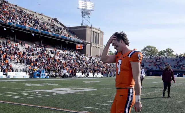 Illinois quarterback Luke Altmyer walks off the field after his team's 25-17 loss to Minnesota in an NCAA college football game Saturday, Nov. 2, 2024, in Champaign, Ill. (AP Photo/Charles Rex Arbogast)