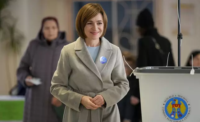 Moldova's President Maia Sandu smiles after casting her vote during a presidential election runoff, in Chisinau, Moldova, Sunday, Nov. 3, 2024. (AP Photo/Vadim Ghirda)