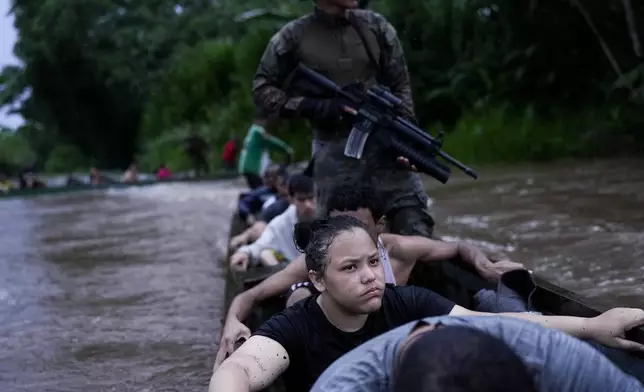 Mariannis Zanzonetti rides on a boat with Venezuelan migrants who asked foe help from Panamanian border police along the Tuquesa River near Bajo Chiquito, Panama, after being robbed by armed men following their crossing of the Darién Gap from Colombia en route to the United States, Friday, Nov. 8, 2024. (AP Photo/Matias Delacroix)