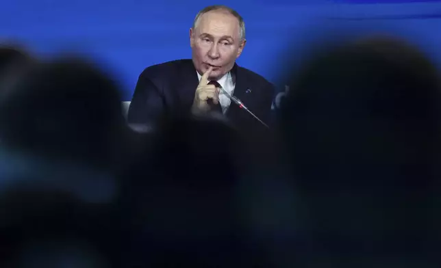 Russian President Vladimir Putin gestures as he answers to a question during a meeting with foreign policy experts at the Valdai Discussion Club in the Black Sea resort of Sochi, Russia, Thursday, Nov. 7, 2024. (Maxim Shipenkov/Pool Photo via AP)