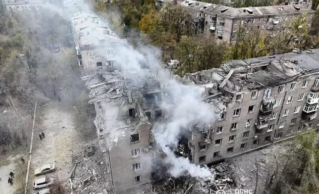 In this image provided by the Ukrainian Emergency Service on Monday, Nov. 11, 2024, a smoke rises out of an apartments building after a Russian attack in Kryvyi Rih, Ukraine. (Ukrainian Emergency Service via AP)