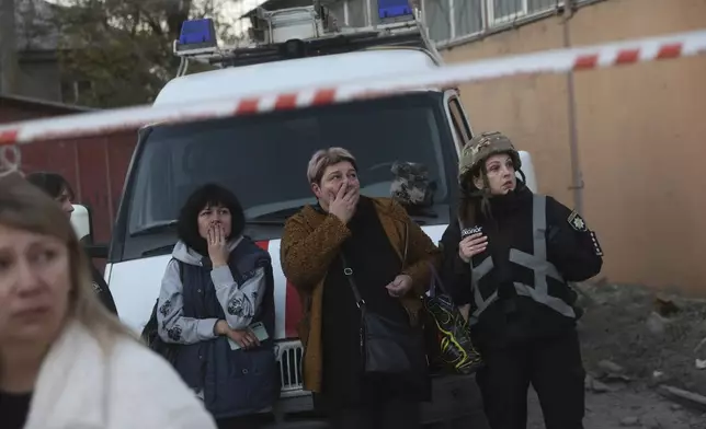 Local women react on destruction of a residential building destroyed by a Russian airstrike in Zaporizhzhia, Ukraine, Thursday, Nov. 7, 2024. (AP Photo/Kateryna Klochko)