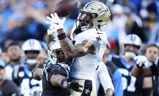 Carolina Panthers cornerback Michael Jackson breaks up a pass intended for New Orleans Saints wide receiver Cedrick Wilson Jr. to end an NFL football game Sunday, Nov. 3, 2024, in Charlotte, N.C. (AP Photo/Jacob Kupferman)