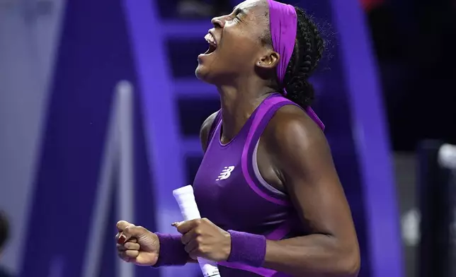 Coco Gauff of the U.S. reacts after winning against China's Qinwen Zheng in their women's singles final match of the WTA finals at the King Saud University Indoor Arena, in Riyadh, Saudi Arabia, Saturday, Nov. 9, 2024. (AP Photo)