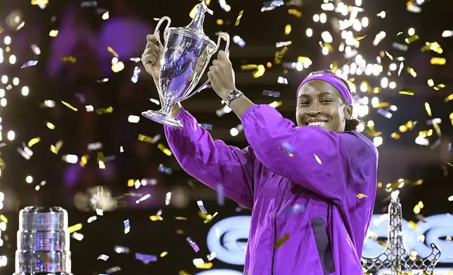 Coco Gauff of the U.S. holds her trophy after winning against China's Qinwen Zheng in their women's singles final match of the WTA finals at the King Saud University Indoor Arena, in Riyadh, Saudi Arabia, Saturday, Nov. 9, 2024. (AP Photo)