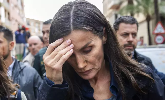 Spain's Queen Letizia reacts as she visits people affected by the floods in Paiporta, near Valencia, Spain, Sunday Nov. 3, 2024. (AP Photo/David Melero)