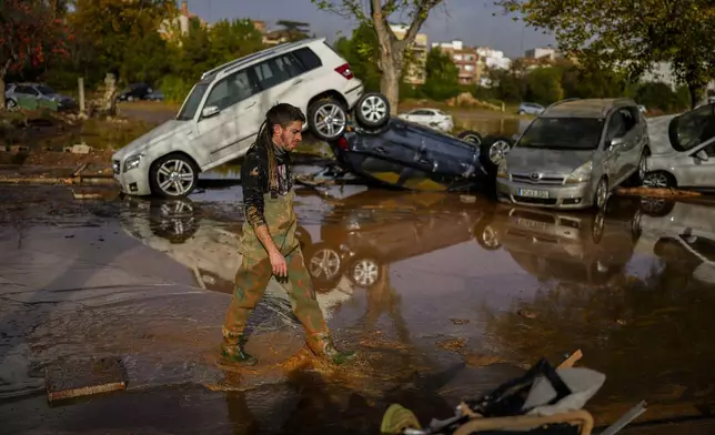 Flooded cars are piled up in Utiel, Spain, Wednesday, Oct. 30, 2024. (AP Photo/Manu Fernandez)