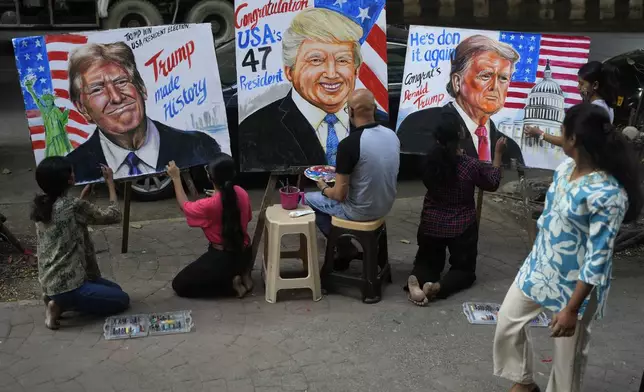 Students of Gurukul School of Art paint portraits of U.S. President-elect Donald Trump in Mumbai, India, Wednesday, Nov. 6, 2024. (AP Photo/Rafiq Maqbool)