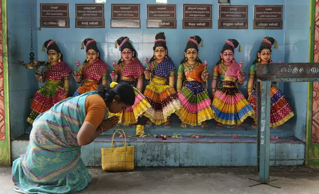 A villager prays in front of the idols of Hindu goddesses after special prayers for the victory of Democratic presidential nominee Vice President Kamala Harris, at Sri Dharmasastha temple in Thulasendrapuram, the ancestral village of Harris, in Tamil Nadu state, India, Tuesday, Nov. 5, 2024. (AP Photo/Aijaz Rahi)