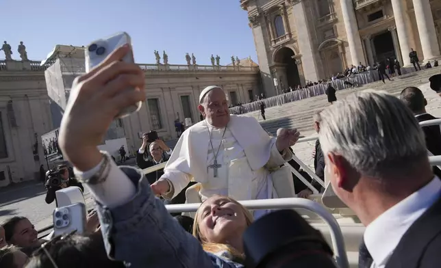 Pope Francis leaves at the end of the weekly general audience in St. Peter's Square, at the Vatican, Wednesday, Nov. 6, 2024. (AP Photo/Alessandra Tarantino)