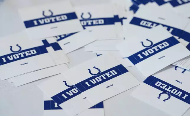 "I Voted" stickers featuring the logo of the Indianapolis Colts are given to voters at a polling location inside the Lucas Oil Stadium, home of the Colts, in Indianapolis, Tuesday, Nov. 5, 2024. (AP Photo/Michael Conroy)