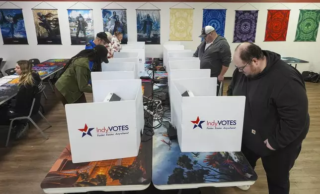 Voters cast their ballots at voting site at The Game Preserve store on Election Day in Indianapolis, Tuesday, Nov. 5, 2024. (AP Photo/Michael Conroy)