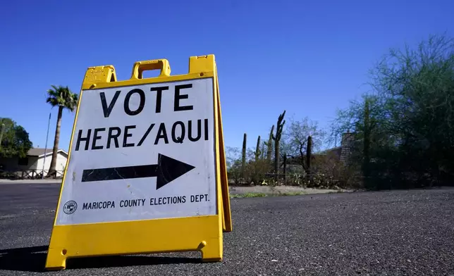 FILE - A sign marks the entrance to a voting precinct on the first day of early voting in the general election in Phoenix, Oct. 12, 2022. (AP Photo/Ross D. Franklin, File)