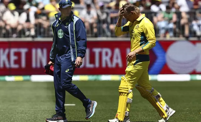 Australia's Cooper Connolly, right, walks off as he retires hurt during their one day international cricket match against Pakistan in Perth, Australia, Sunday, Nov. 10, 2024. (AP Photo/Trevor Collens)