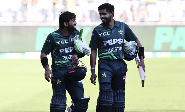 Pakistan's not out batters Mohammad Rizwan, left, and Babar Azam smile after their win in their one day international cricket match against Australia in Perth, Australia, Sunday, Nov. 10, 2024. (AP Photo/Trevor Collens)