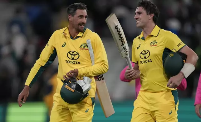 Australia's not-out batters Pat Cummins, right, and Mitchell Starc walk off the ground after their win over Pakistan during their one day international cricket match in Melbourne, Monday, Nov. 4, 2024. (AP Photo/Asanka Brendon Ratnayake)