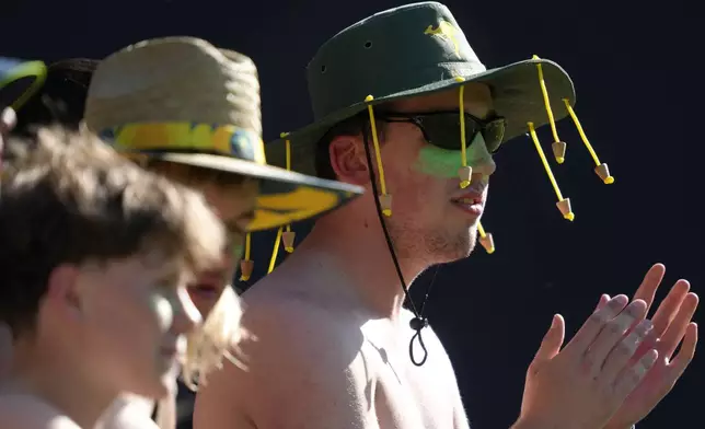 A fan wears a cork hat while watching Australia and Pakistan during their one day international cricket match in Melbourne, Monday, Nov. 4, 2024. (AP Photo/Asanka Brendon Ratnayake)