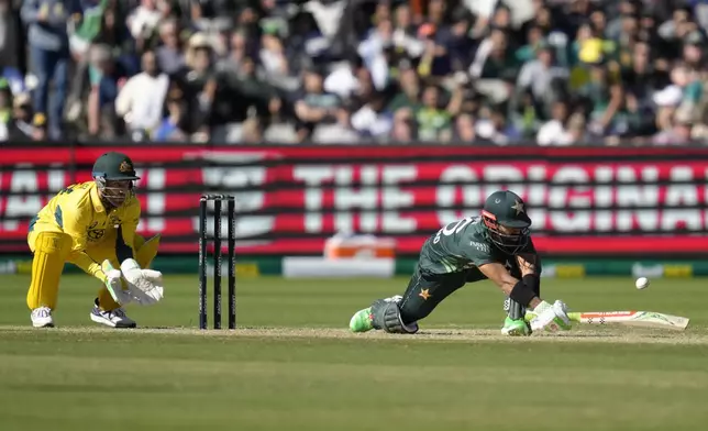 Pakistan's Mohammad Rizwan, right, attempts a sweep shot but edges that ball and will be caught out by Australia's Josh Inglis, left, during their one day international cricket match in Melbourne, Monday, Nov. 4, 2024. (AP Photo/Asanka Brendon Ratnayake)