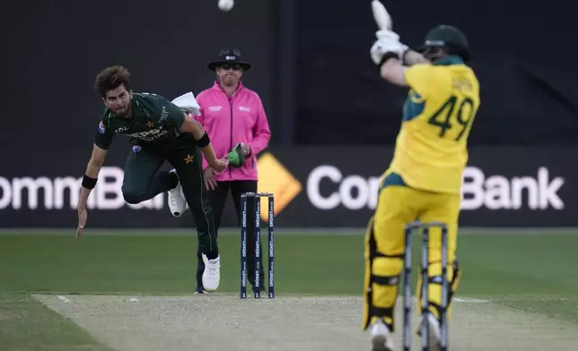 Pakistan's Shaheen Shah Afridi, left, bowls to Australia's Steve Smith during their one day international cricket match in Melbourne, Monday, Nov. 4, 2024. (AP Photo/Asanka Brendon Ratnayake)