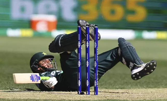 Pakistan's Saim Ayub falls over while batting against Australia during their one day international cricket match in Perth, Australia, Sunday, Nov. 10, 2024. (AP Photo/Trevor Collens)