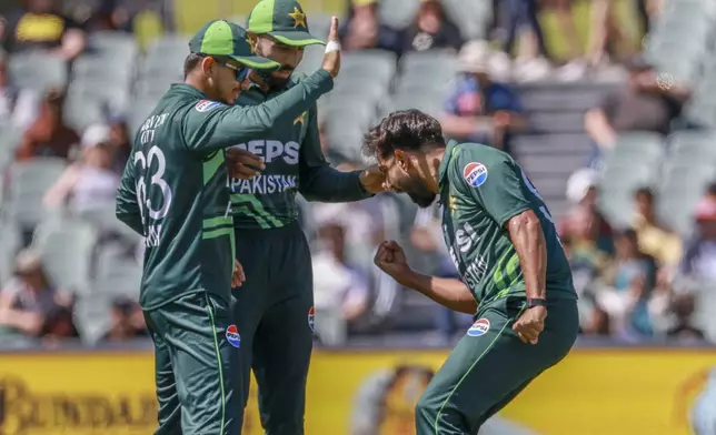 Pakistan's Haris Rauf, right, celebrates with teammates after the dismissal of Australia's Marnus Labuschagne during the second one day international cricket match between Australia and Pakistan in Adelaide, Friday, Nov. 8, 2024. (AP Photo/James Elsby)