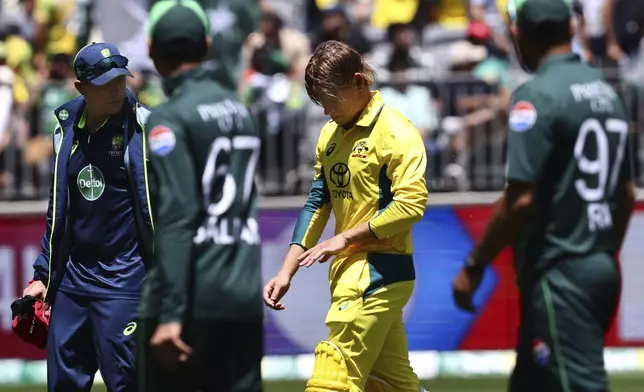 Australia's Cooper Connolly, second right, walks off as he retires hurt during their one day international cricket match against Pakistan in Perth, Australia, Sunday, Nov. 10, 2024. (AP Photo/Trevor Collens)