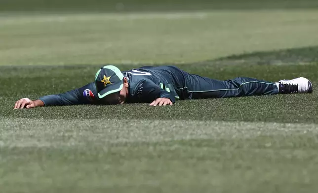 Pakistan's Saim Ayub Alyson the ground after a failed catches attempt against Australia during their one day international cricket match in Perth, Australia, Sunday, Nov. 10, 2024. (AP Photo/Trevor Collens)