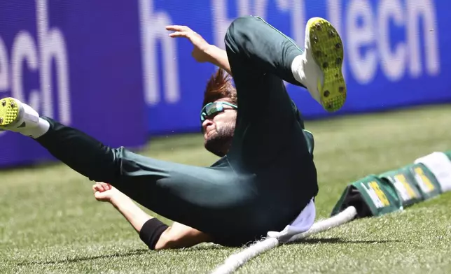 Pakistan's Shaheen Shah Afridi tumbles over the boundary while fielding against Australia during their one day international cricket match in Perth, Australia, Sunday, Nov. 10, 2024. (AP Photo/Trevor Collens)