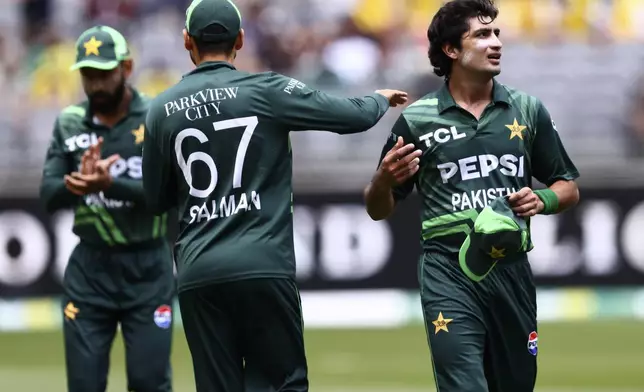 Pakistan's Naseem Shah, right, is congratulated by teammate Salman Ali Agha after taking the wicket of Australia's Jake Fraser-McGurk during their one day international cricket match in Perth, Australia, Sunday, Nov. 10, 2024. (AP Photo/Trevor Collens)