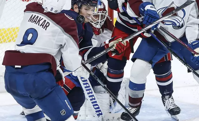 Winnipeg Jets' Cole Perfetti (91) keeps his eye on the puck after it hits Colorado Avalanche's Cale Makar (8) during the third period of an NHL hockey game Thursday, Nov. 7, 2024 in Winnipeg, Manitoba. (John Woods/The Canadian Press via AP)