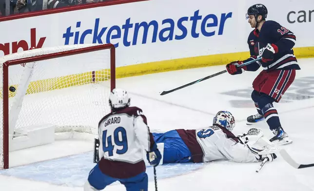 Winnipeg Jets' Gabriel Vilardi (13) scores on Colorado Avalanche goaltender Alexandar Georgiev (40) during the first period of an NHL hockey game Thursday, Nov. 7, 2024 in Winnipeg, Manitoba. (John Woods/The Canadian Press via AP)