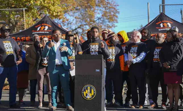 Baltimore Mayor Brandon Scott, center, speaks during a press conference to celebrate achieving over 365 days without a homicide within the Brooklyn neighborhood Safe Streets catchment zone, Tuesday, Nov. 12, 2024, in Baltimore. (AP Photo/Stephanie Scarbrough)