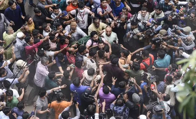 Students from anti-discrimination movements and Bangladesh Nationalist Party activists attack an Awami League supporter in Dhaka, Bangladesh, Sunday, Nov. 10, 2024. (AP Photo/Mahmud Hossain Opu)