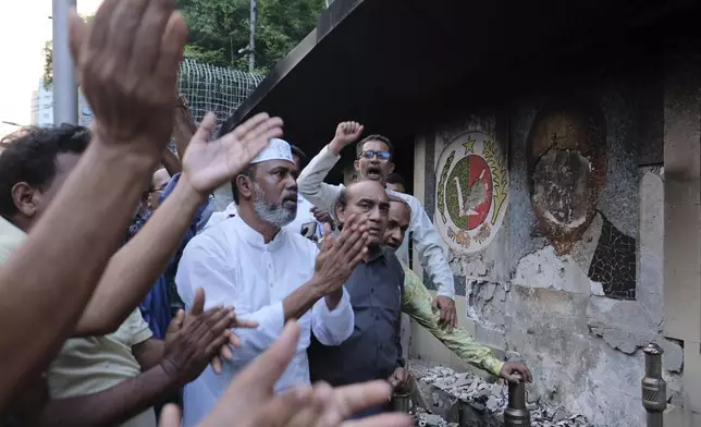 Supporters of the Jatiya Party that supports the country's ousted leader Sheikh Hasina, protest outside a vandalised party office, in Dhaka, Bangladesh, Friday, Nov. 1, 2024. (AP Photo/Mahmud Hossain Opu)