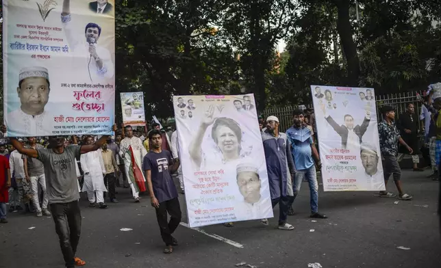 Bangladesh Nationalist Party (BNP) activists participate in a rally carrying the photographs of their leaders, in Dhaka, Bangladesh, Friday, Nov. 8, 2024. (AP Photo/Mahmud Hossain Opu)