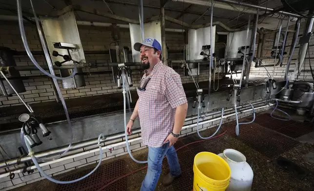 Aubrey Jarrell owner of Jarrell Bros. Dairy Farm in Kentwood, La., walks past milking equipment just before his cows' 3:00 PM milking, Wednesday, Oct. 30, 2024. (AP Photo/Gerald Herbert)